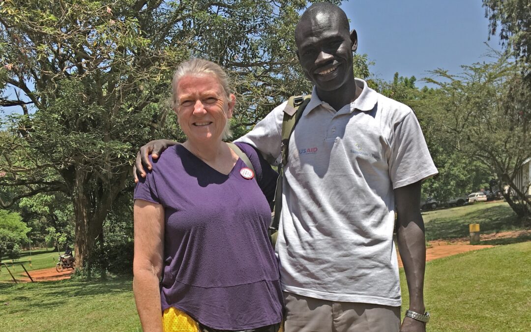 anglican missionary smiling with US aid employee